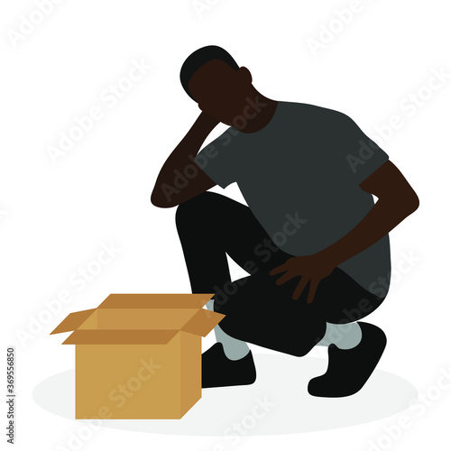 Black man squatting near empty box