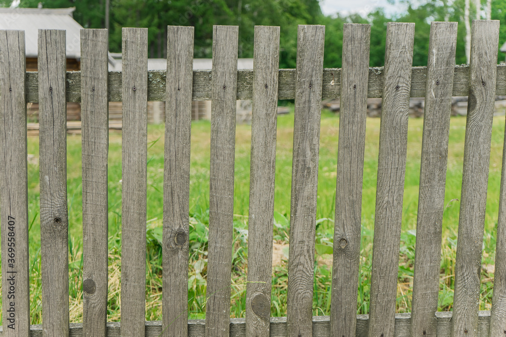 a rustic fence made of untreated wooden planks