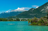 View of Annecy lake,boats with tourists and Alps mountains on sunny day with blue sky in Annecy city.Annecy is the largest city of Haute-Savoie department in France.