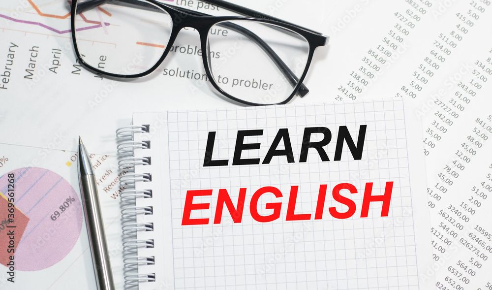 LEARN ENGLISH writing on the Notepad view from above business concepts LEARN ENGLISH writing on the Notepad view from above business concepts