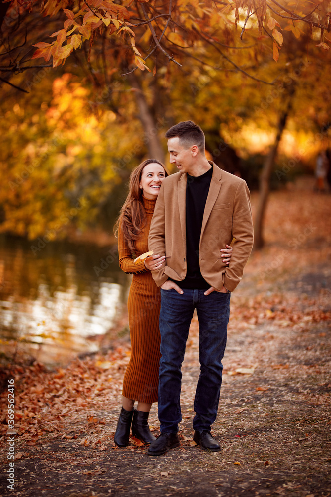 pregnant with husband in autumn Park by river. pregnant with husband in autumn Park by river.