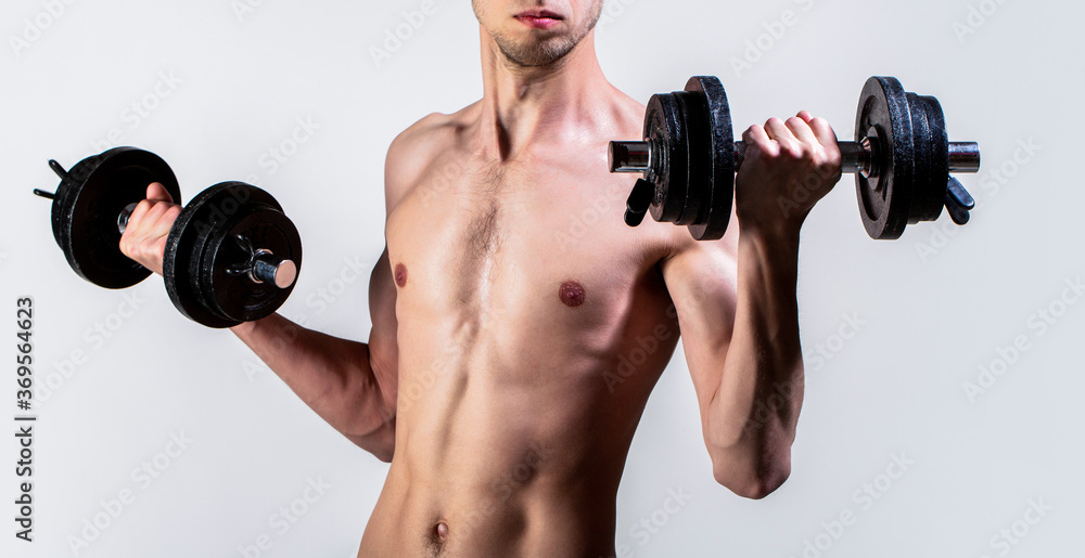 Man holding dumbbell in hand. Skinny guy hold dumbbells up in hands. A thin guy in sports with dumbbells. Weak man lift a weight, dumbbells, biceps, muscle, fitness. Nerd guy raising a dumbbell Man holding dumbbell in hand. Skinny guy hold dumbbells up in hands. A thin guy in sports with dumbbells. Weak man lift a weight, dumbbells, biceps, muscle, fitness. Nerd guy raising a dumbbell