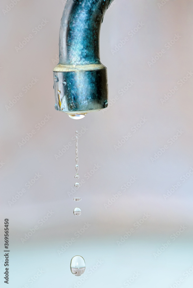 Leaking water drops from the unturned tap Leaking water drops from the unturned tap