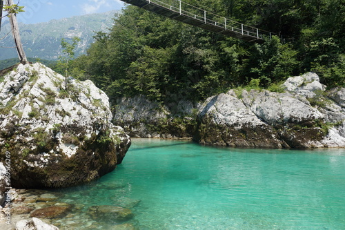 Ice cold Soca river with stunning turquoise blue crystal clear waters. Picture taken in Kobarid, on the way to Kozjak waterfall.