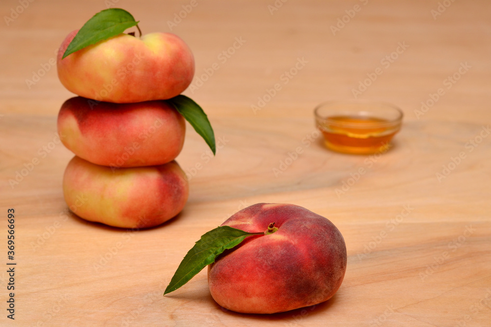 summer still life with fruit flat peaches and honey on the table summer still life with fruit flat peaches and honey on the table