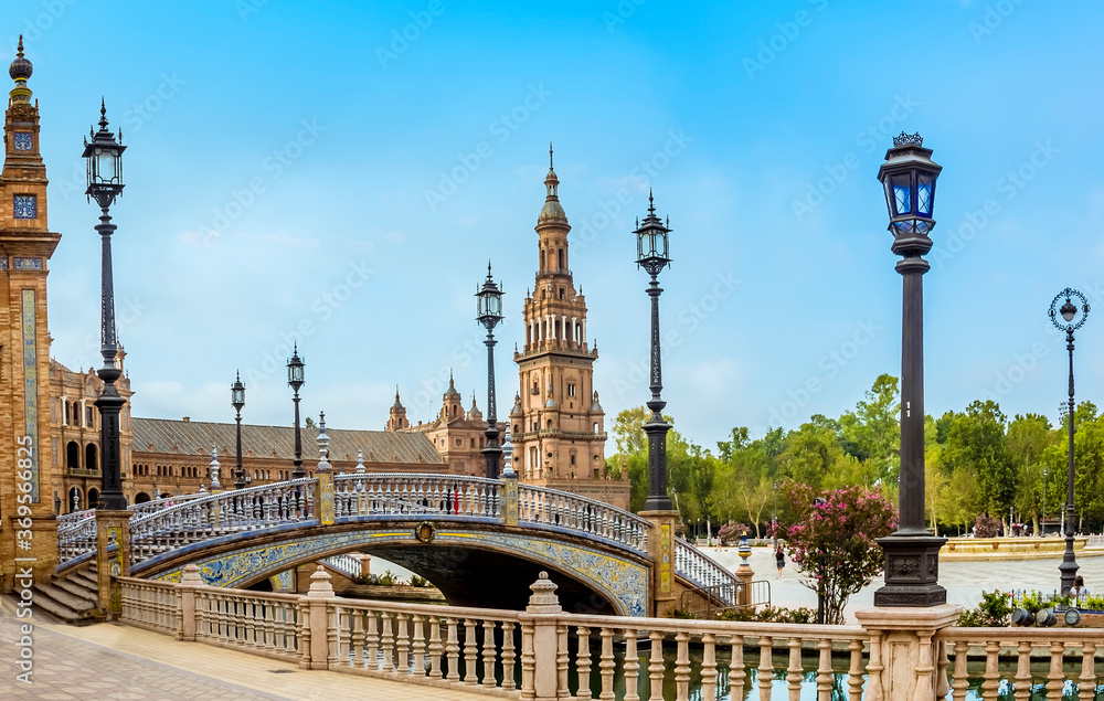 A view of an art deco bridge on the southern side of the Plaza de Espana in Seville, Spain in the stillness of the early morning in summertime