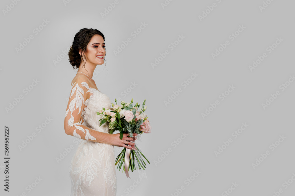 Bride in white wedding dress with bouquet in studio on white blank background right side. Advert for social networks for wedding agency and bridal salon Bride in white wedding dress with bouquet in studio on white blank background right side. Advert for social networks for wedding agency and bridal salon