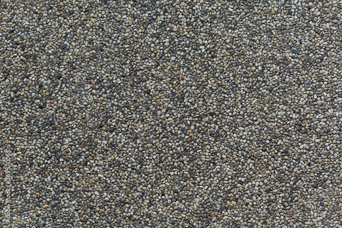 Closeup of exposed concrete made of small pebbles in different shades of brown and gray