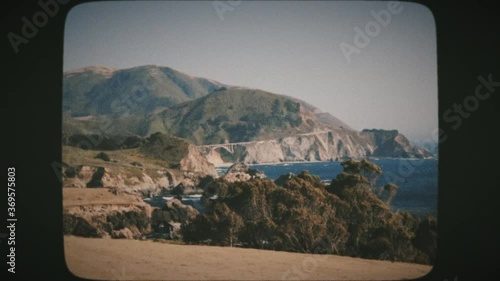 Driving view of Bixby Creek Bridge and Big Sur Area from Highway One in California. Vintage Film Look.