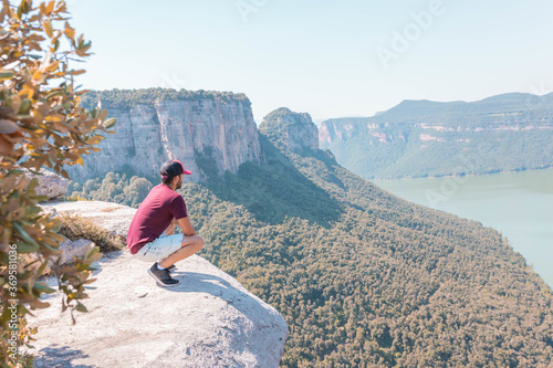 Young male enjoying the mesmerizing scenery of the Morro de la Abeja in Tavertet, Catalonia, Spain photo