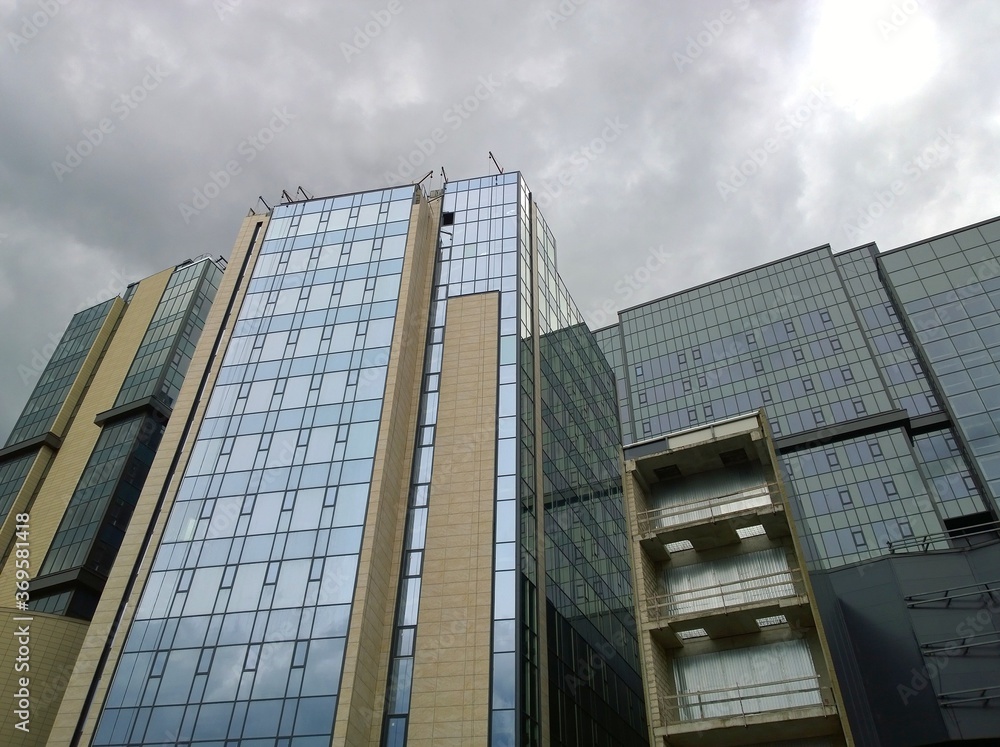 Fototapeta premium Buildings of new expo and convention corporate business center. Glass exterior. Rental commercial real estate. Cityscape. Office park. Overcast sky. Economic and financial concept. Urban architecture.