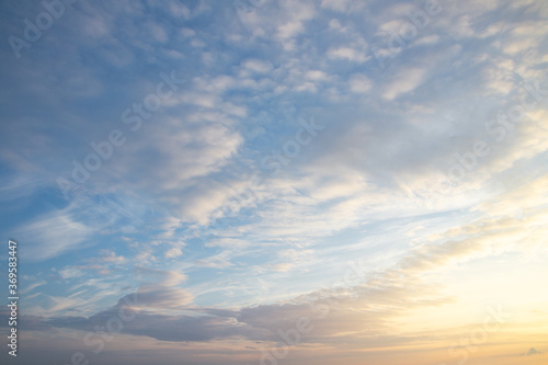 white and pink Cirrus clouds on a blue sky on a summer evening, background