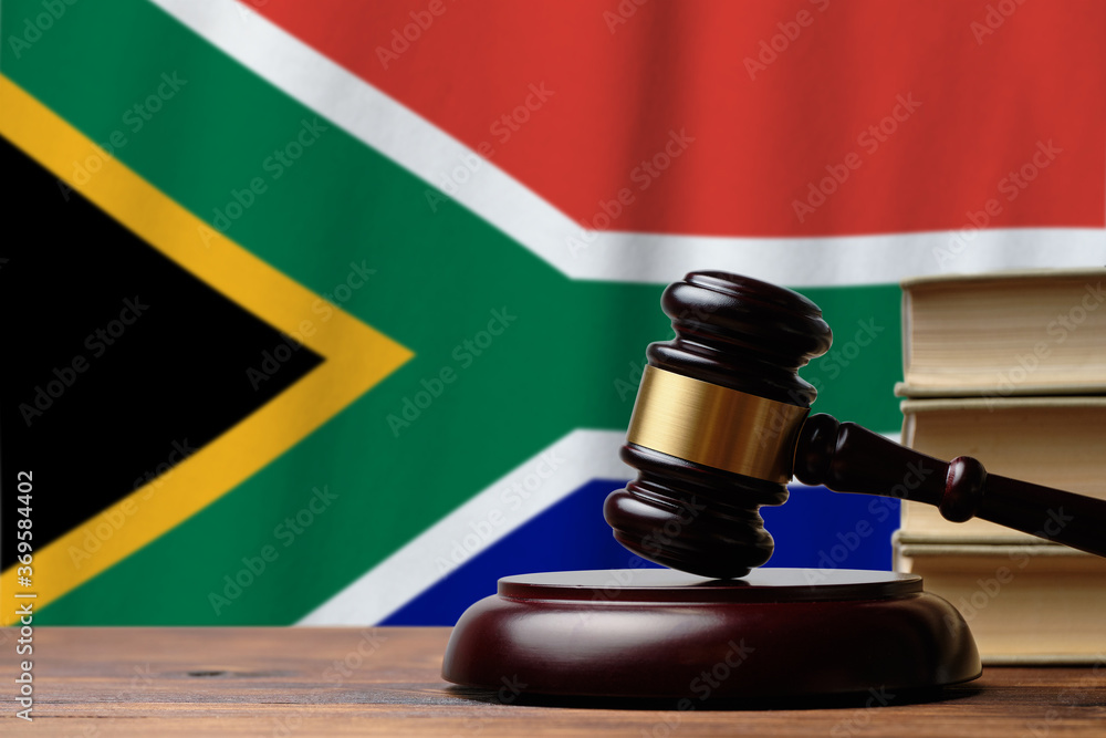 Justice and court concept in Republic of South Africa. Judge hammer on a flag background