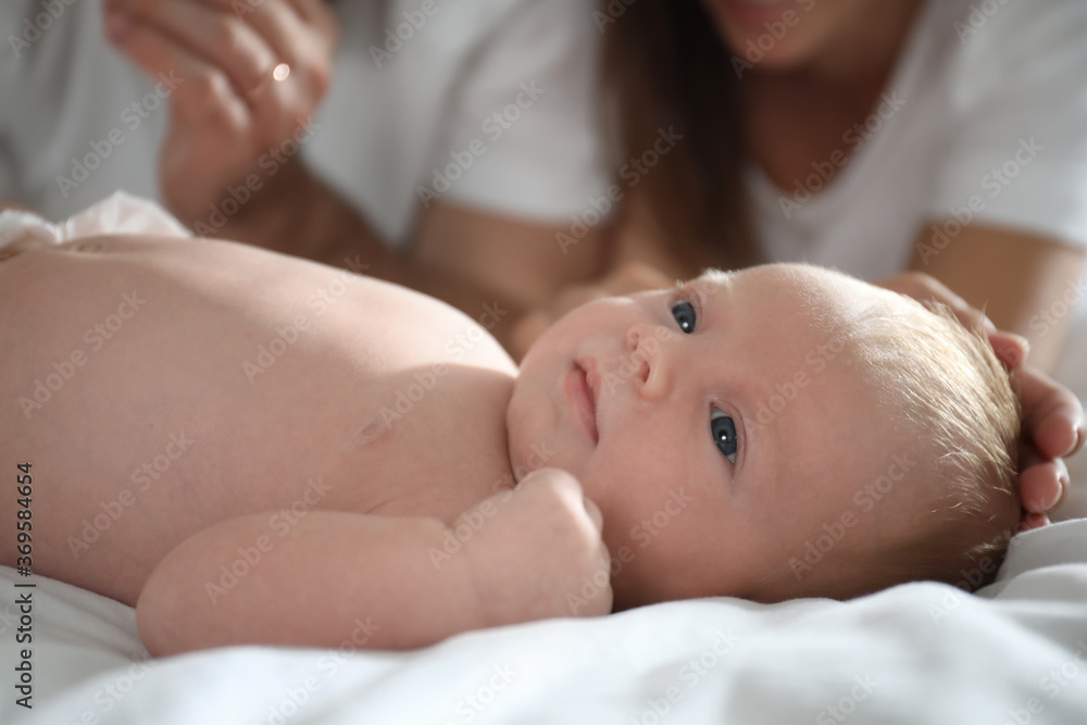 Newborn baby lying near parent on bed, closeup Newborn baby lying near parent on bed, closeup