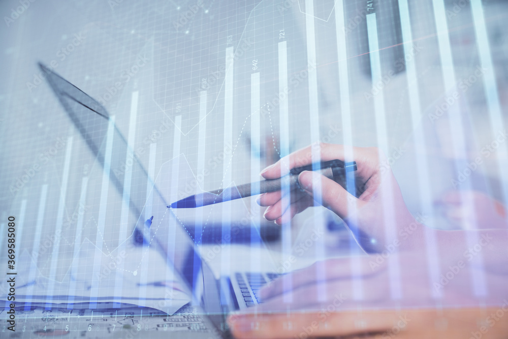 Multi exposure of woman hands typing on computer and financial graph hologram drawing. Stock market analysis concept. Multi exposure of woman hands typing on computer and financial graph hologram drawing. Stock market analysis concept.