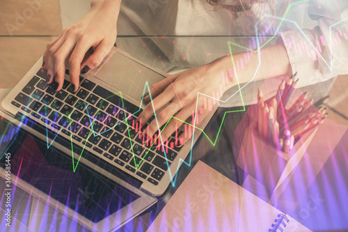 Double exposure of woman hands typing on computer and forex chart hologram drawing. Stock market invest concept.