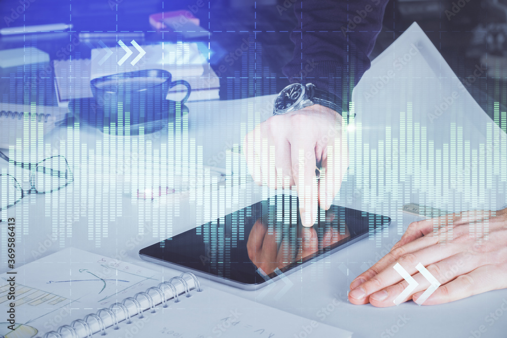 Double exposure of man's hands holding and using a digital device and forex graph drawing. Financial market concept. Double exposure of man's hands holding and using a digital device and forex graph drawing. Financial market concept.