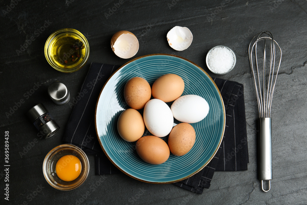 Flat lay composition with chicken eggs on black table Flat lay composition with chicken eggs on black table