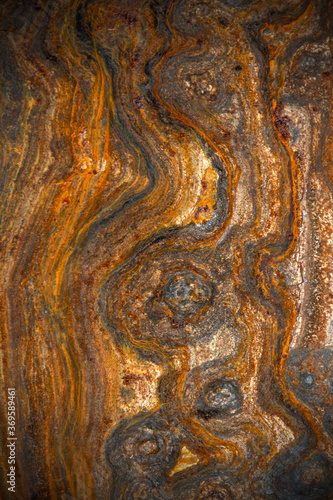 metal surface with curly rust, stains of different degrees of oxidation