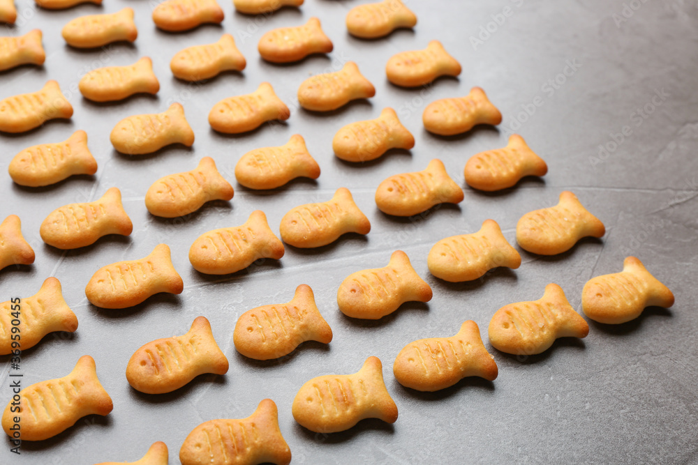 Delicious goldfish crackers on grey table, closeup