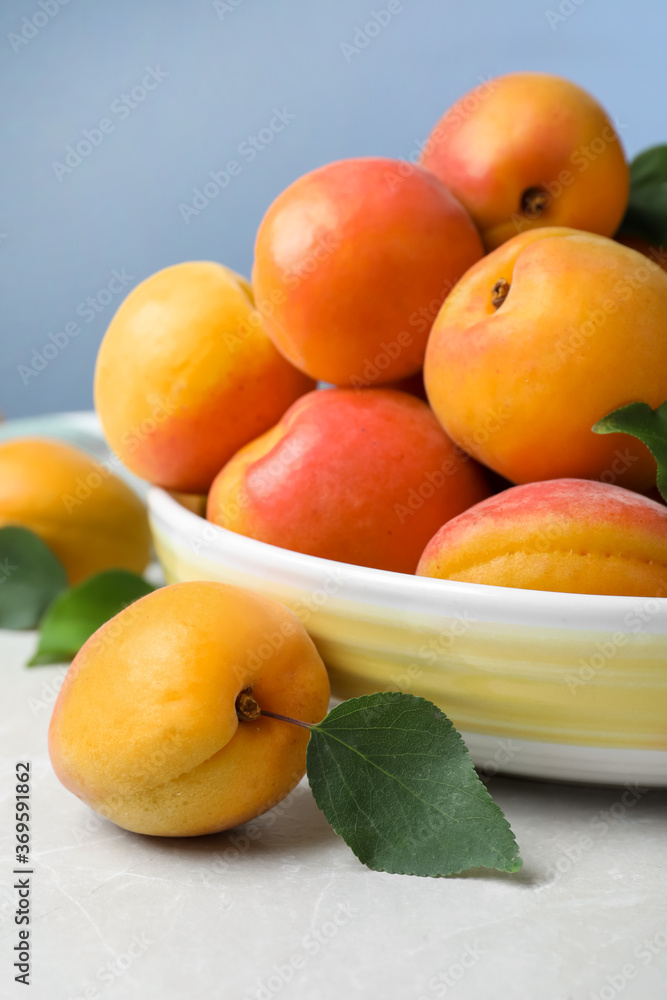 Delicious fresh ripe apricots on white table Delicious fresh ripe apricots on white table