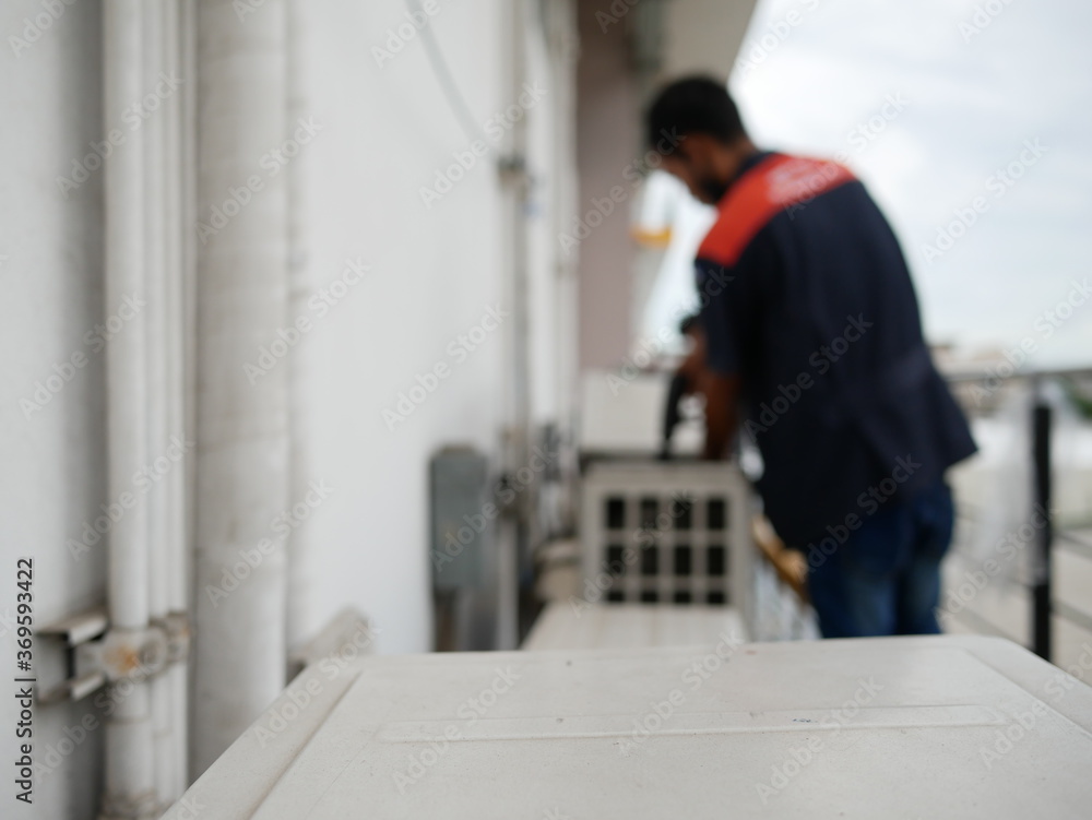 blurred of technician cleaning air conditioner at office. blurred of technician cleaning air conditioner at office.