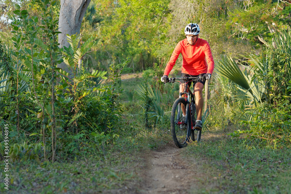Naklejka premium Man mountain biking in Dominican Republic. .
