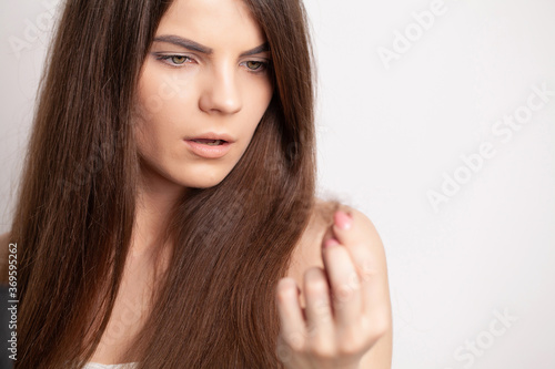Very upset young woman has a problem with hair loss
