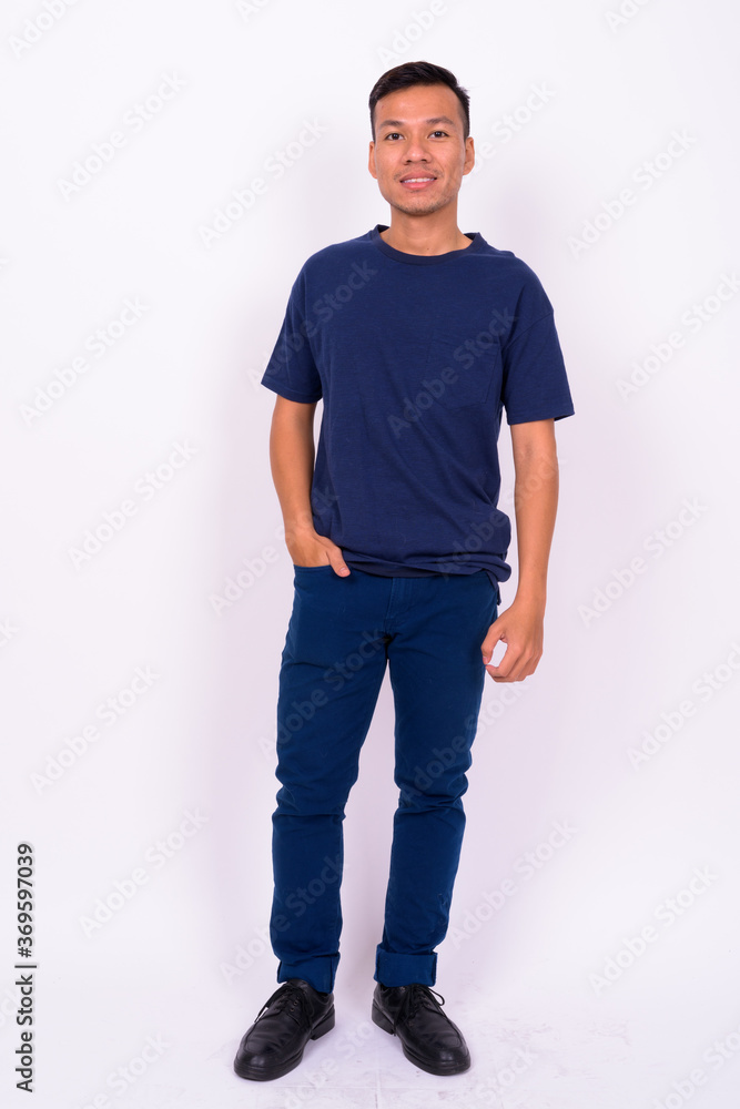 Fototapeta premium Portrait of happy young Asian man with beard stubble