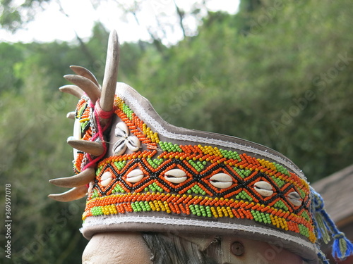 Photography the head wear with wild boar tusks armlet and colorful beads is traditional cult