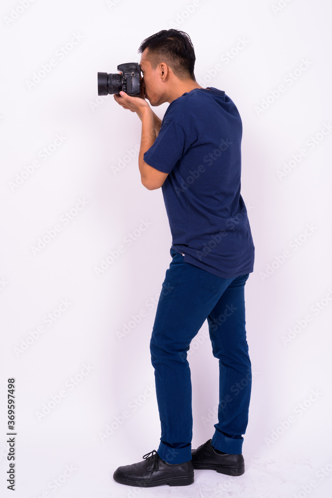 Portrait of young Asian man with camera Portrait of young Asian man with camera