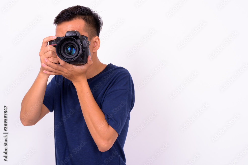 Portrait of young Asian man with camera Portrait of young Asian man with camera
