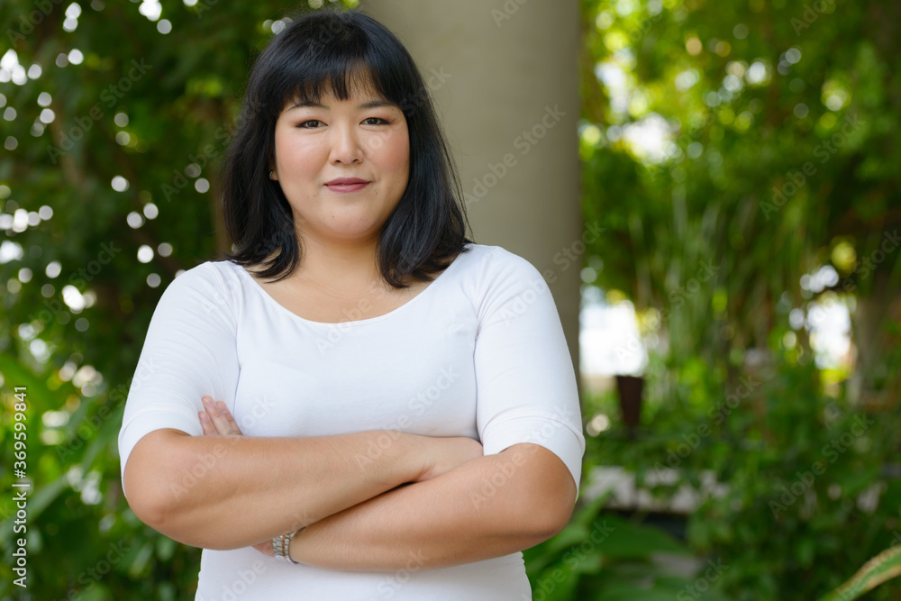 Young beautiful overweight Asian woman at the park Young beautiful overweight Asian woman at the park