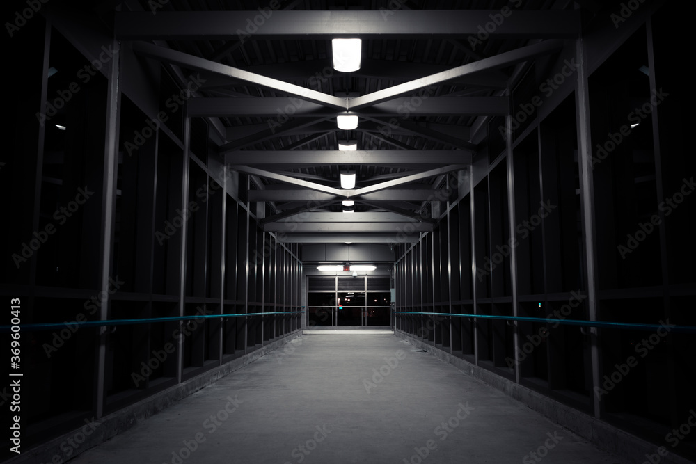 Image of a symmetrical bridge in a dark tunnel