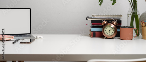 Workspace with laptop, stationery, copy space, books and decorations on white table, clipping path.