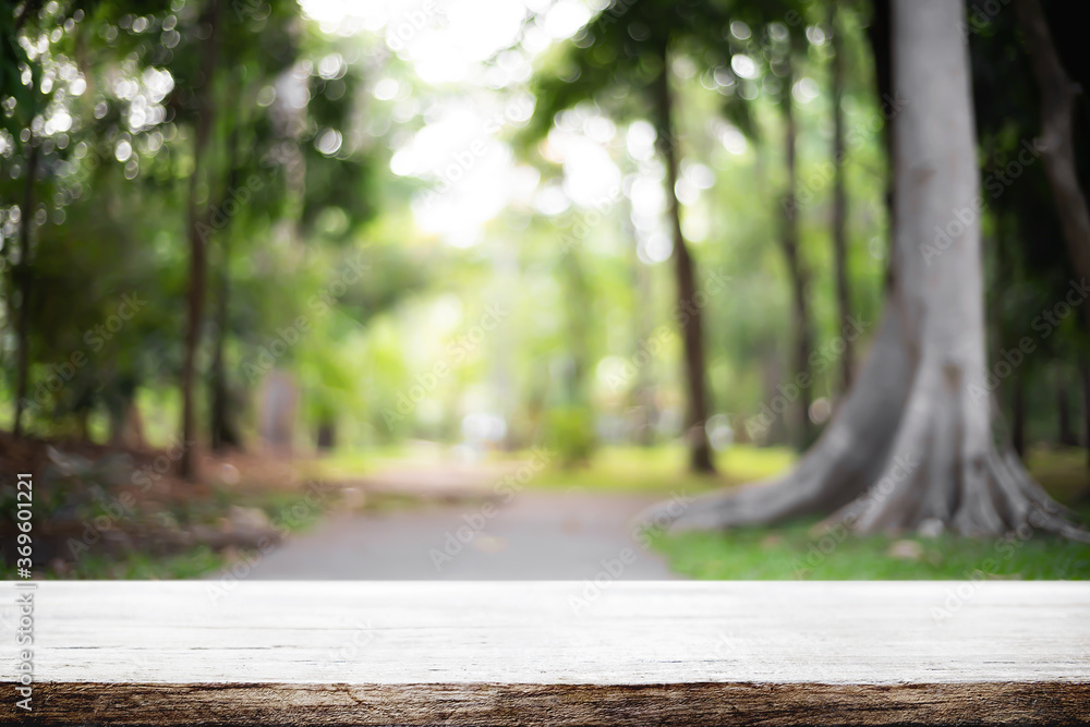Empty wooden desk space and blurry background of garden or park for product display montage. Empty wooden desk space and blurry background of garden or park for product display montage.