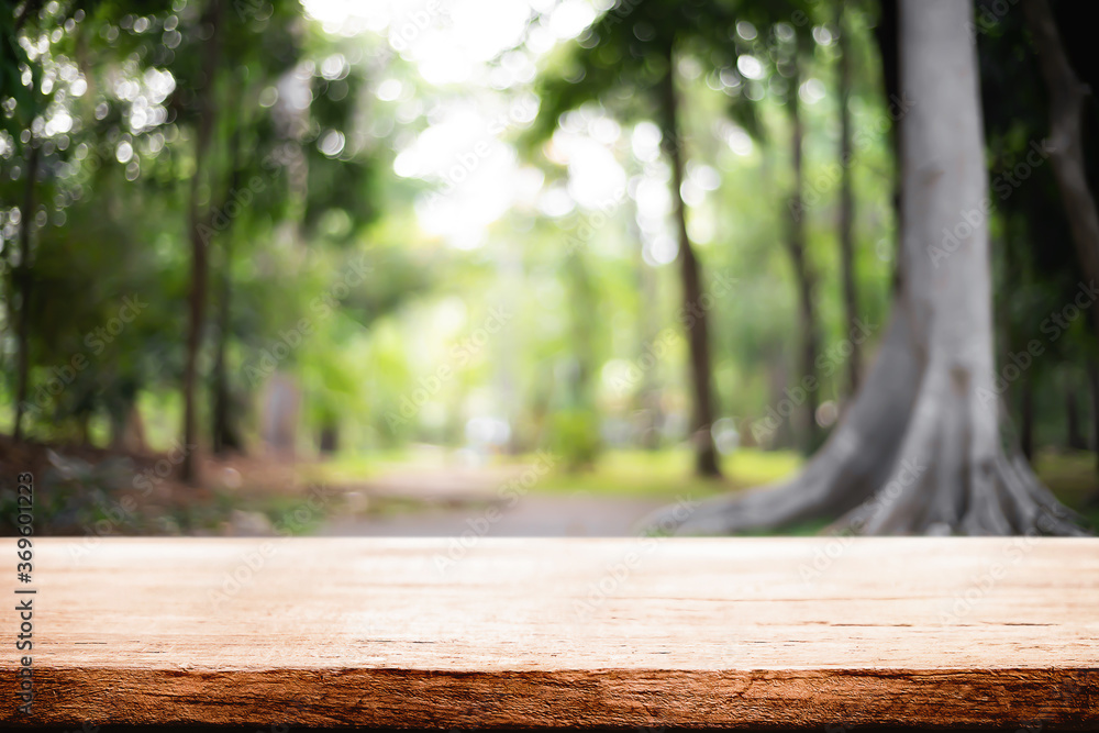 Empty wooden desk space and blurry background of garden or park for product display montage. Empty wooden desk space and blurry background of garden or park for product display montage.