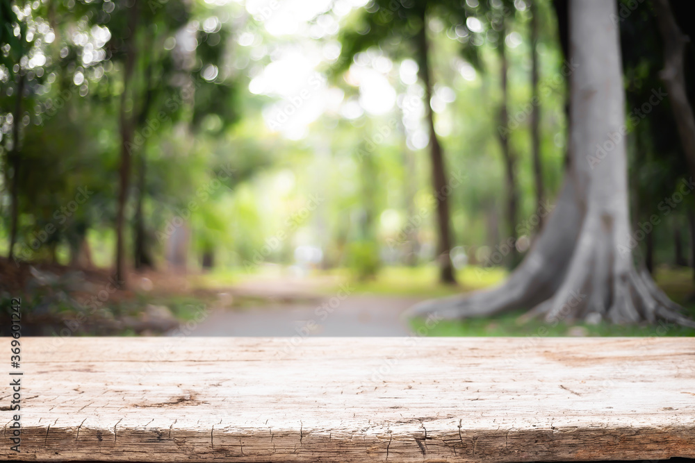 Empty wooden desk space and blurry background of garden or park for product display montage. Empty wooden desk space and blurry background of garden or park for product display montage.