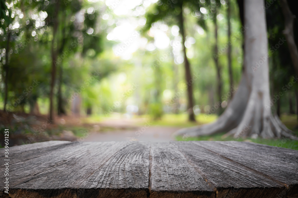 Empty wooden desk space and blurry background of garden or park for product display montage. Empty wooden desk space and blurry background of garden or park for product display montage.