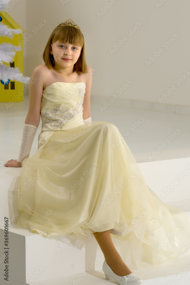 Beautiful little girl is sitting on the white staircase. Beautiful little girl is sitting on the white staircase.