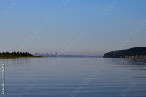 silhouette of the city between the two shores in a pink haze of early morning