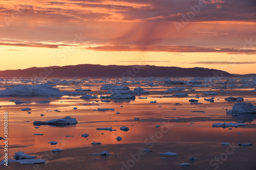 Midnight Sun and icebergs in Disko Bay, Ilulissat, West Greenland