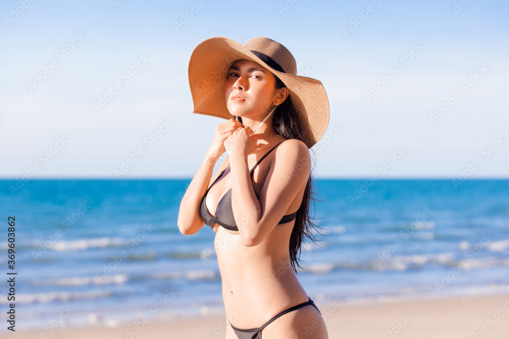 Beautiful sexy asian women in a sexy bikini on tropical beach	