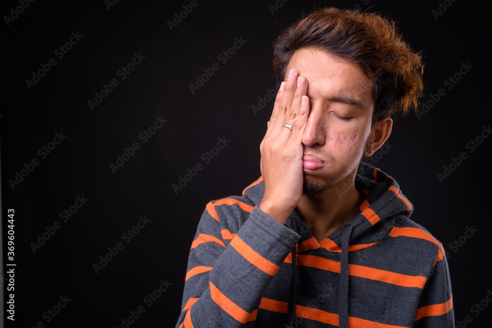 Portrait of young Asian man with curly hair Portrait of young Asian man with curly hair