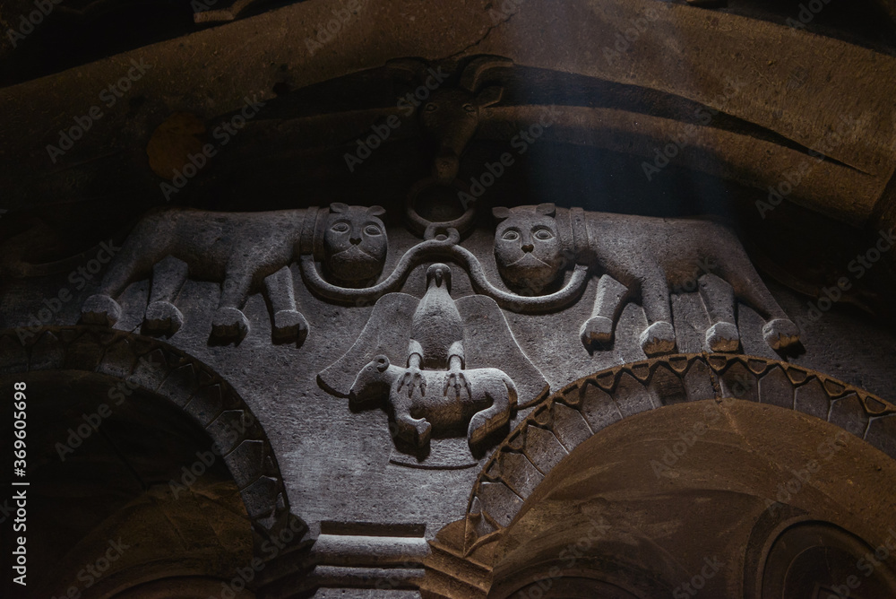 two lions and an eagle carved in column stone inside the Geghard Monastery