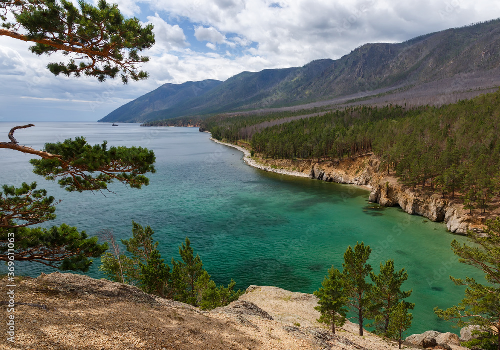 View of Baikal lake from a cliff in Peschanya bay with transparent water and shore line
