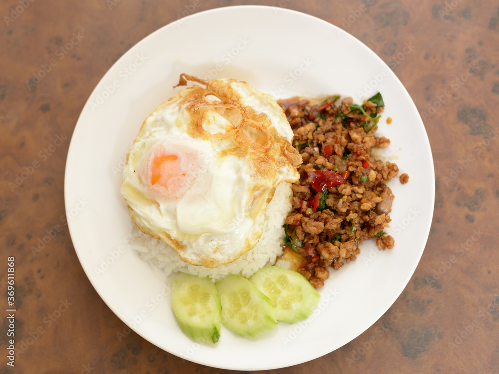 Pad Kra Pao or stir fried chicken with holy basil as traditional Thai food Pad Kra Pao or stir fried chicken with holy basil as traditional Thai food