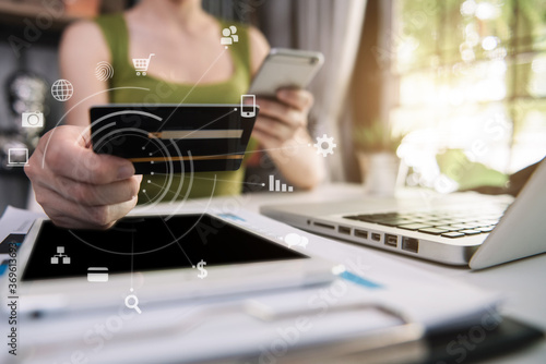 Bild auf Leinwand Female businessman use credit cards to conduct financial transactions through phones, tablet, and laptop
