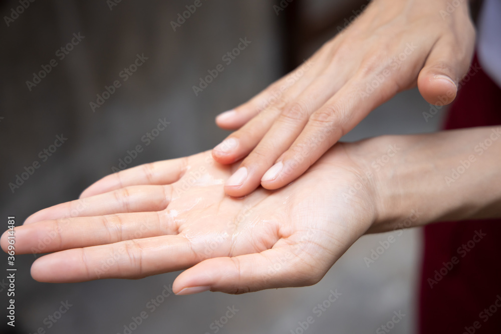 woman washing her hand with alcohol gel or hand sanitizer; new normal lifestyle with COVID-19 pandemic concept woman washing her hand with alcohol gel or hand sanitizer; new normal lifestyle with COVID-19 pandemic concept