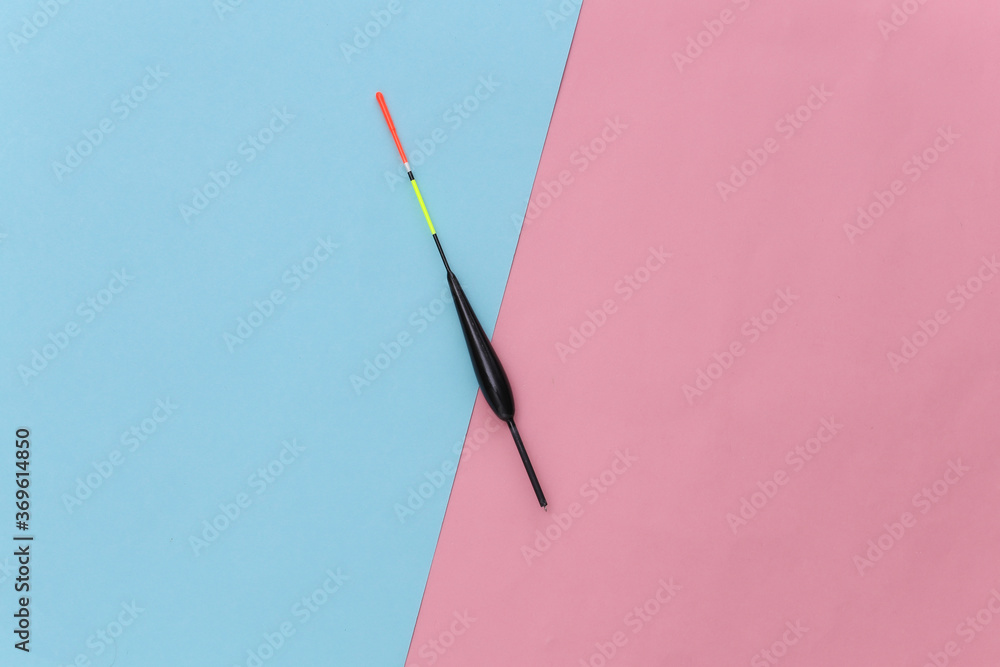 Fishing float on pink blue pastel background. Top view. Minimalism Fishing float on pink blue pastel background. Top view. Minimalism